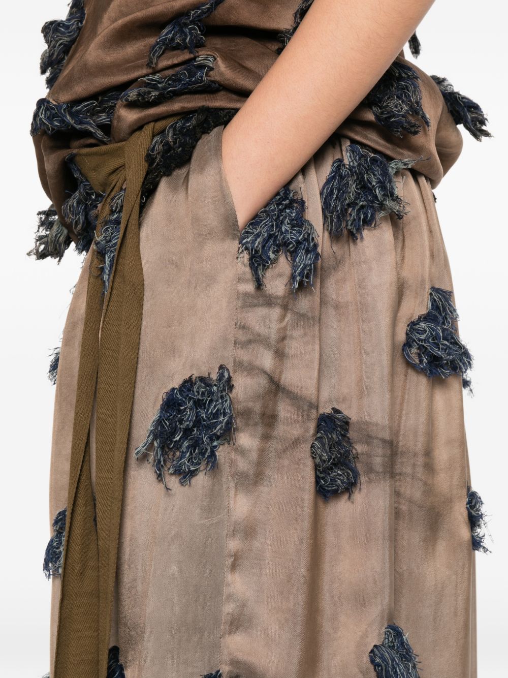Close up of brown skirt, showing texture of the cotton fabric