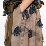 Close up of brown skirt, showing texture of the cotton fabric