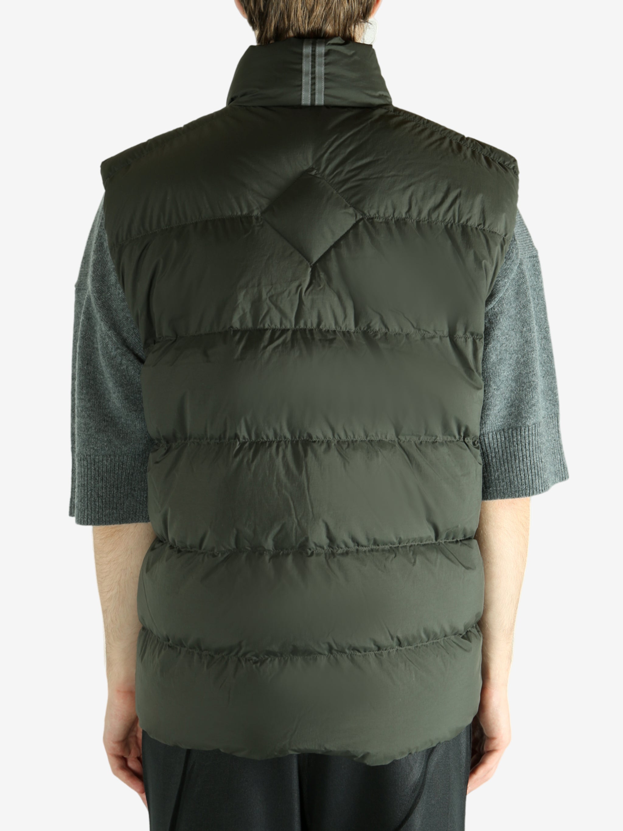 Green vest worn by a person, showing the vest's fit