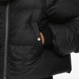 Black jacket worn by a person, showing the jacket fit