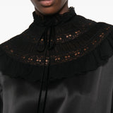Black dress worn by a person, showing the dress fit