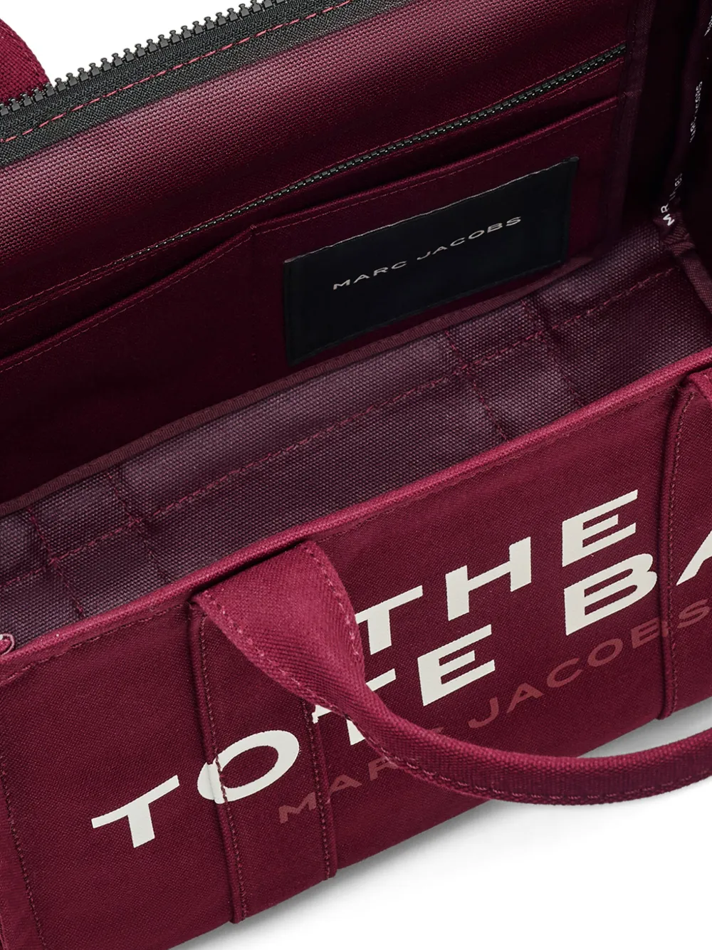 Close up of burgundy bag, showing texture of the cotton fabric