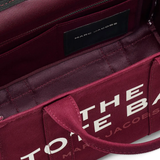 Close up of burgundy bag, showing texture of the cotton fabric