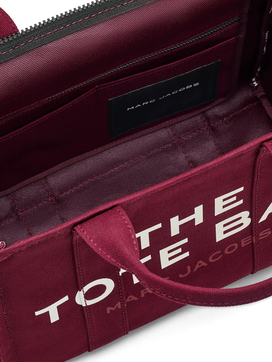 Close up of burgundy bag, showing texture of the cotton fabric