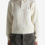 White sweater worn by a person, showing the sweater's fit
