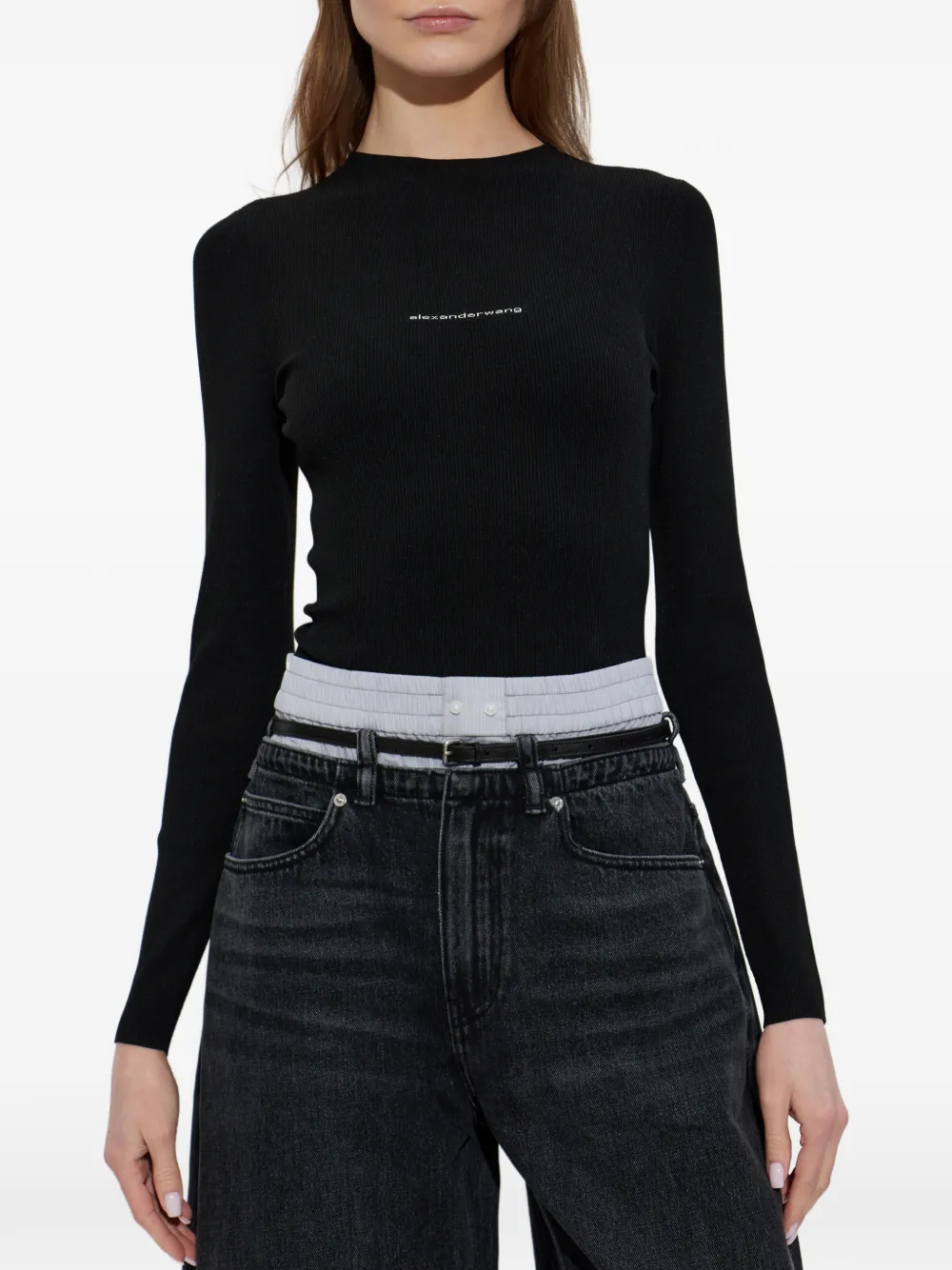 Black top worn by a person, showing the top fit