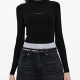 Black top worn by a person, showing the top fit