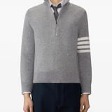 grey knitwear worn by a person, showing the knitwear fit