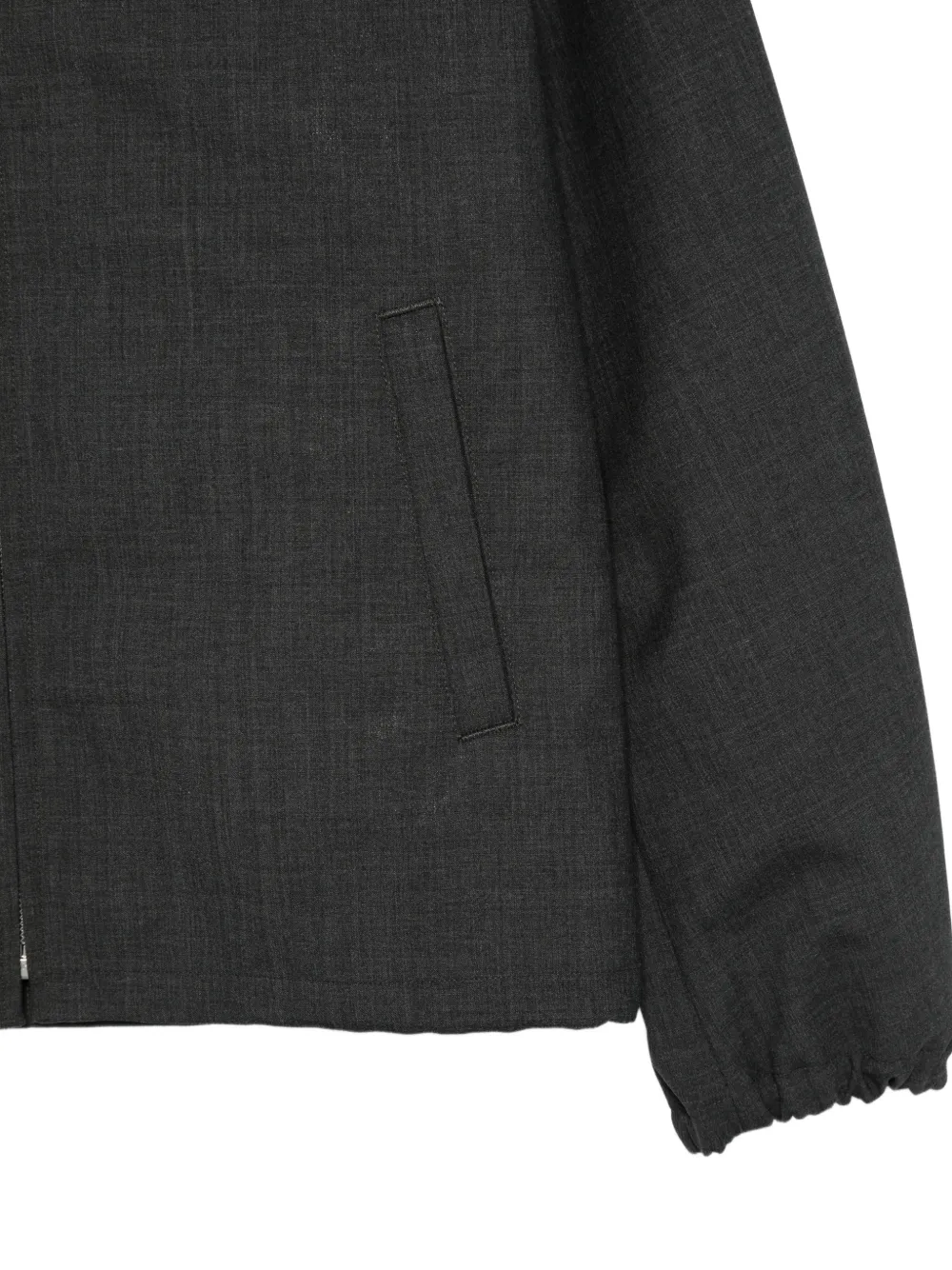 Close up of black jacket, showing texture of the wool fabric
