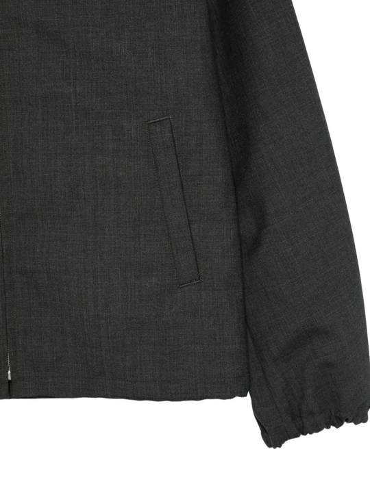 Close up of black jacket, showing texture of the wool fabric