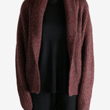 Red cardigan worn by a person, showing the cardigan's fit