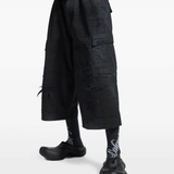 Black pants worn by a person, showing the pants' fit