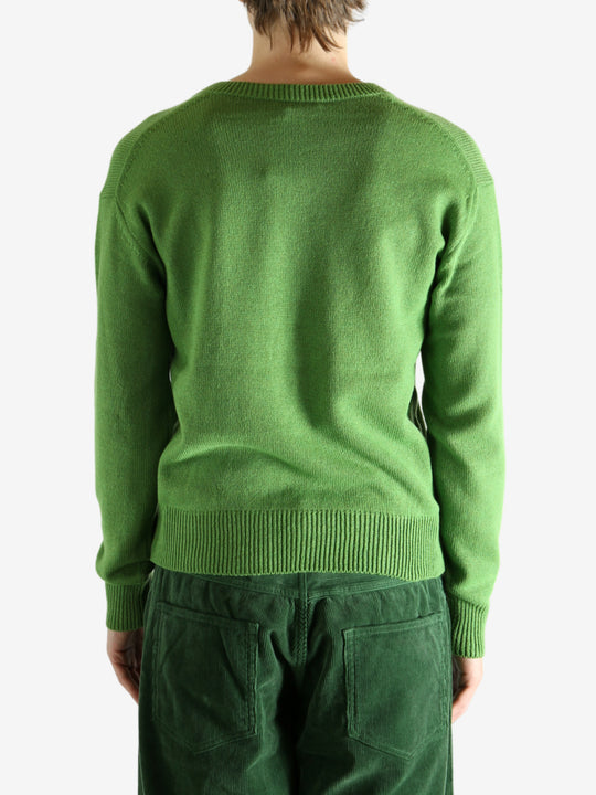 Green knitwear worn by a person, showing the knitwear's fit