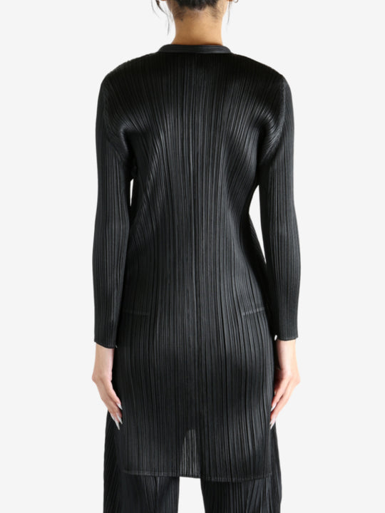 Black shirt worn by a person, showing the shirt's fit