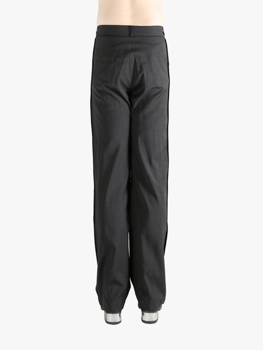 Black pants worn by a person, showing the pants' fit