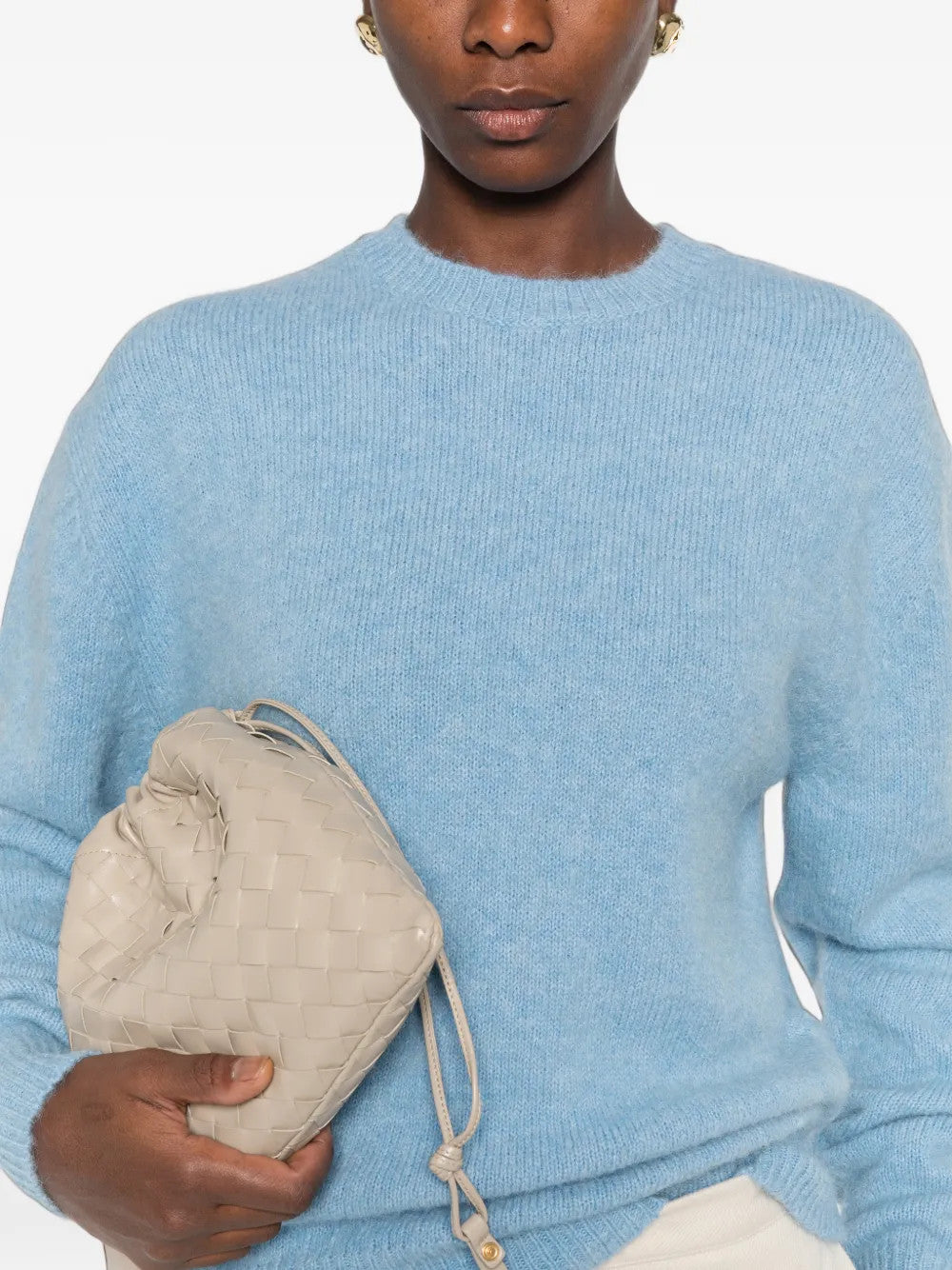 Blue knitwear worn by a person, showing the knitwear fit