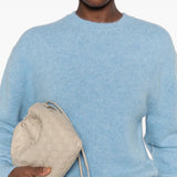 Blue knitwear worn by a person, showing the knitwear fit
