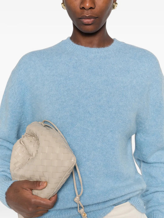 Blue knitwear worn by a person, showing the knitwear fit