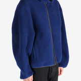 Blue jacket worn by a person, showing the jacket's fit