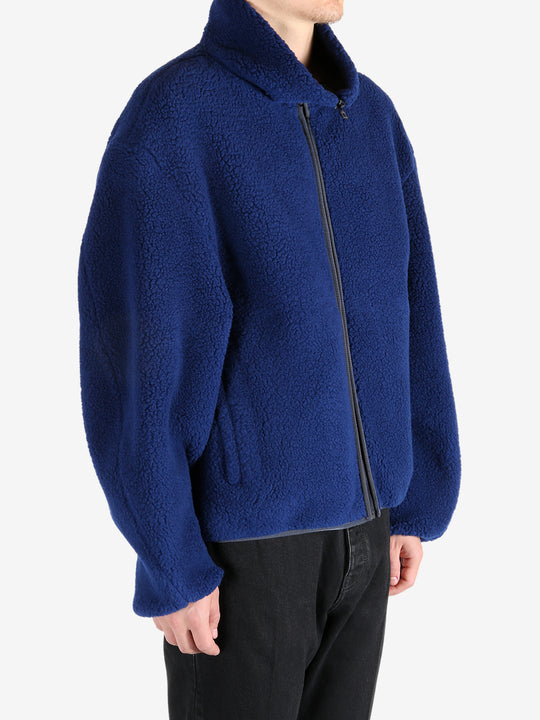 Blue jacket worn by a person, showing the jacket's fit