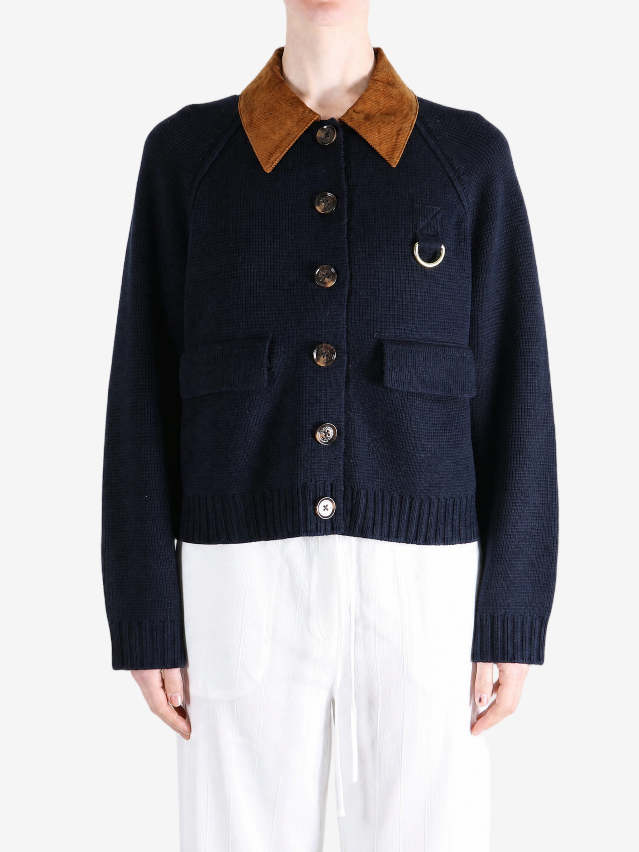Navy knitwear worn by a person, showing the knitwear fit