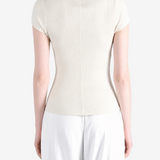 Tan knitwear worn by a person, showing the knitwear fit