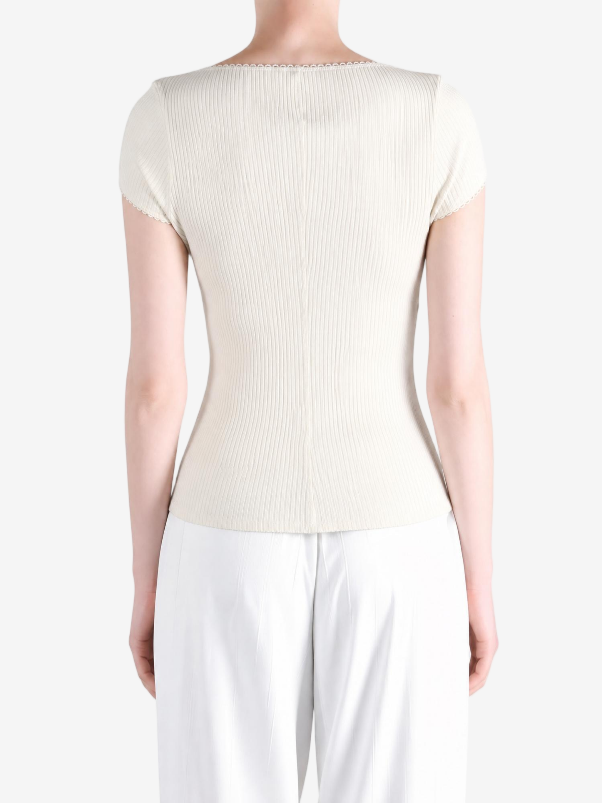 Tan knitwear worn by a person, showing the knitwear fit