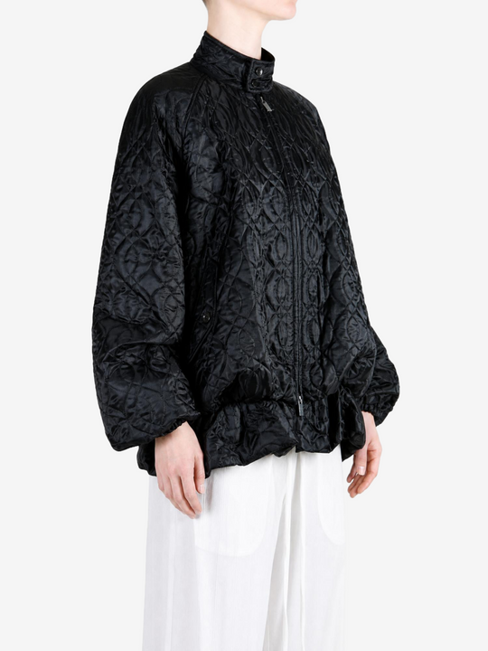 Black jacket worn by a person, showing the jacket fit