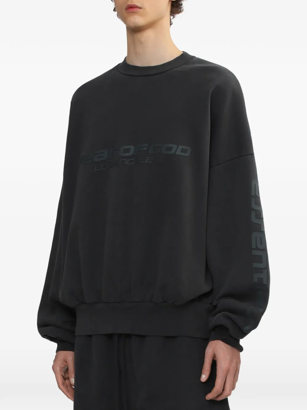 Black sweatshirt worn by a person, showing the sweatshirt's fit