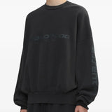 Black sweatshirt worn by a person, showing the sweatshirt's fit