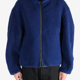 Blue jacket worn by a person, showing the jacket's fit