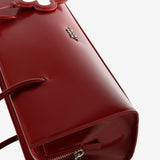 Close up of the red bag, showing texture of the leather fabric