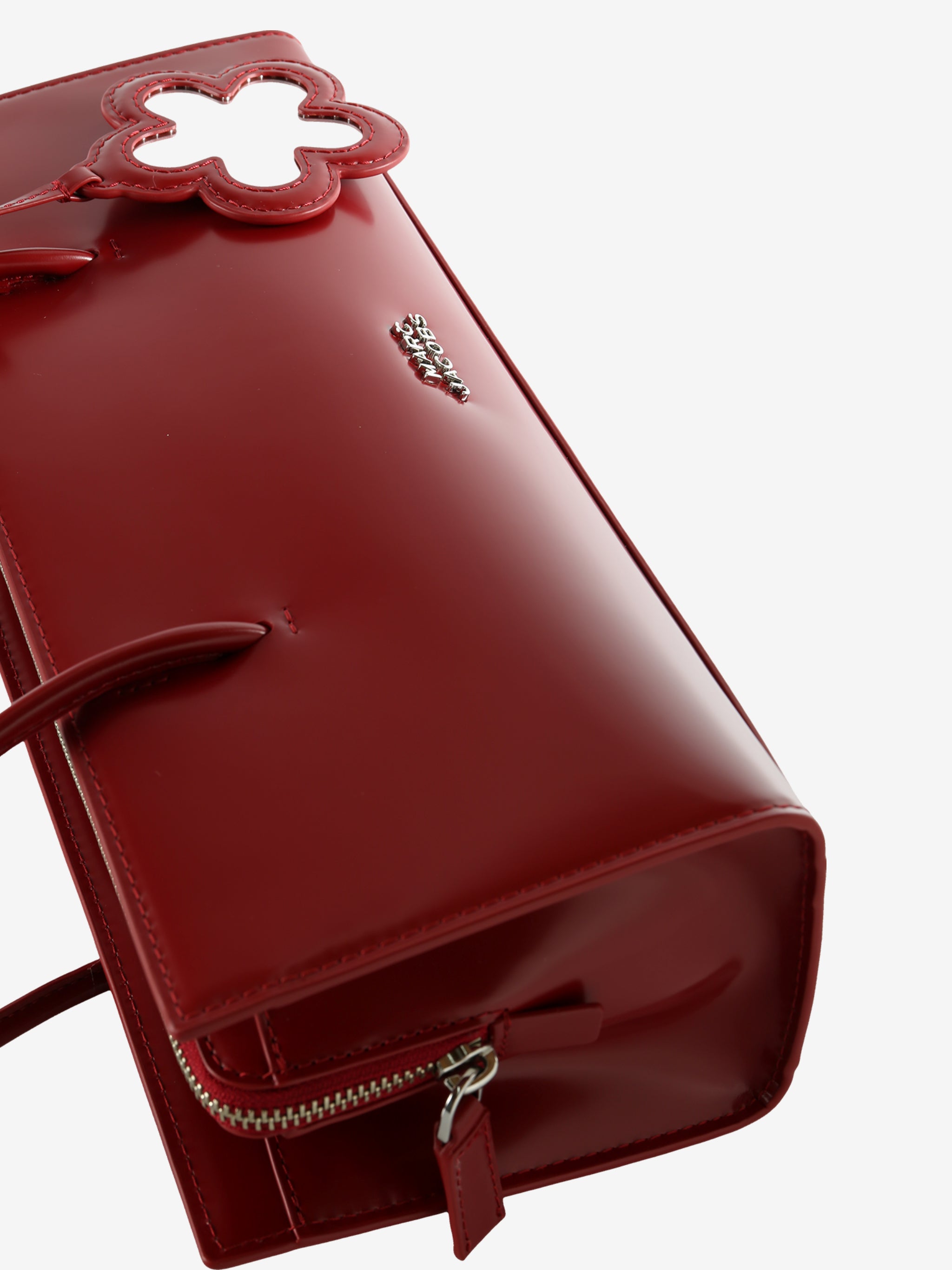 Close up of the red bag, showing texture of the leather fabric