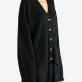 Black knitwear worn by a person, showing the knitwear's fit