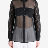 Black top worn by a person, showing the top fit