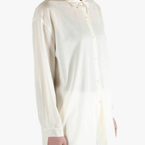 White shirt worn by a person, showing the shirt's fit