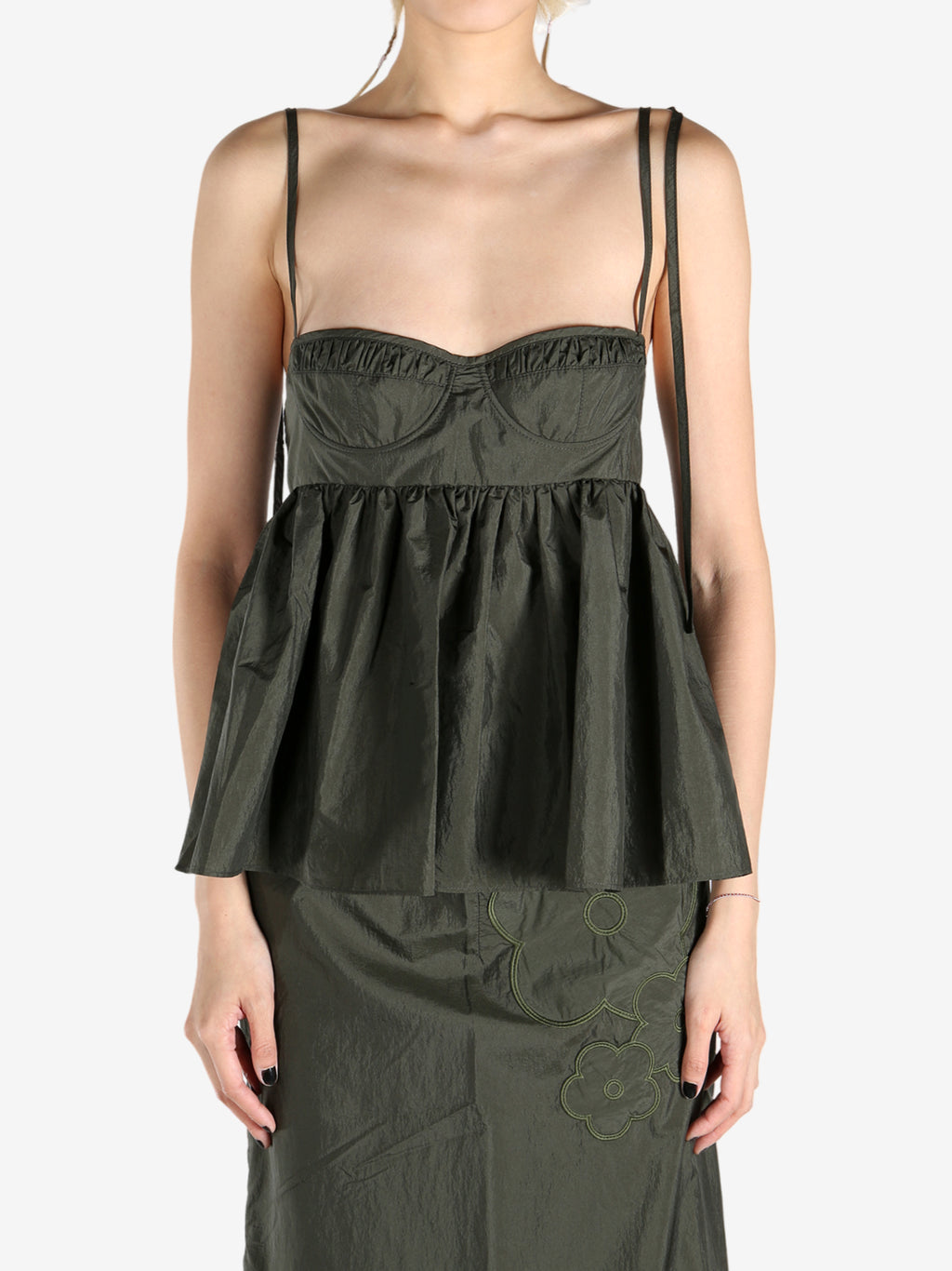 Green tops worn by a person, showing the tops fit