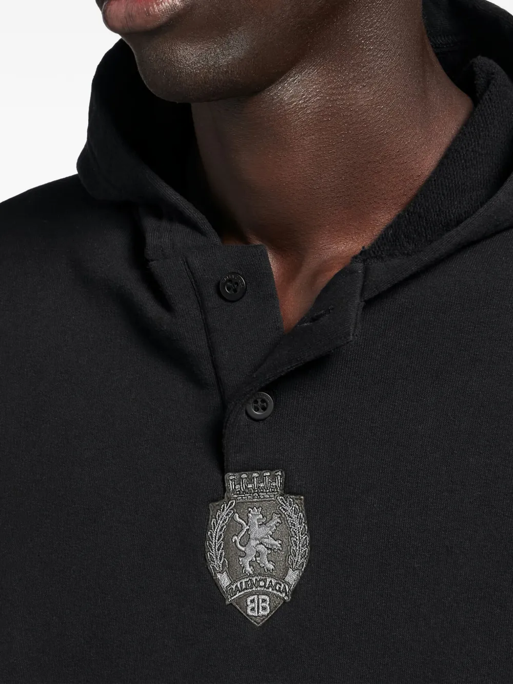 Close up of black hoodie, showing texture of the cotton fabric