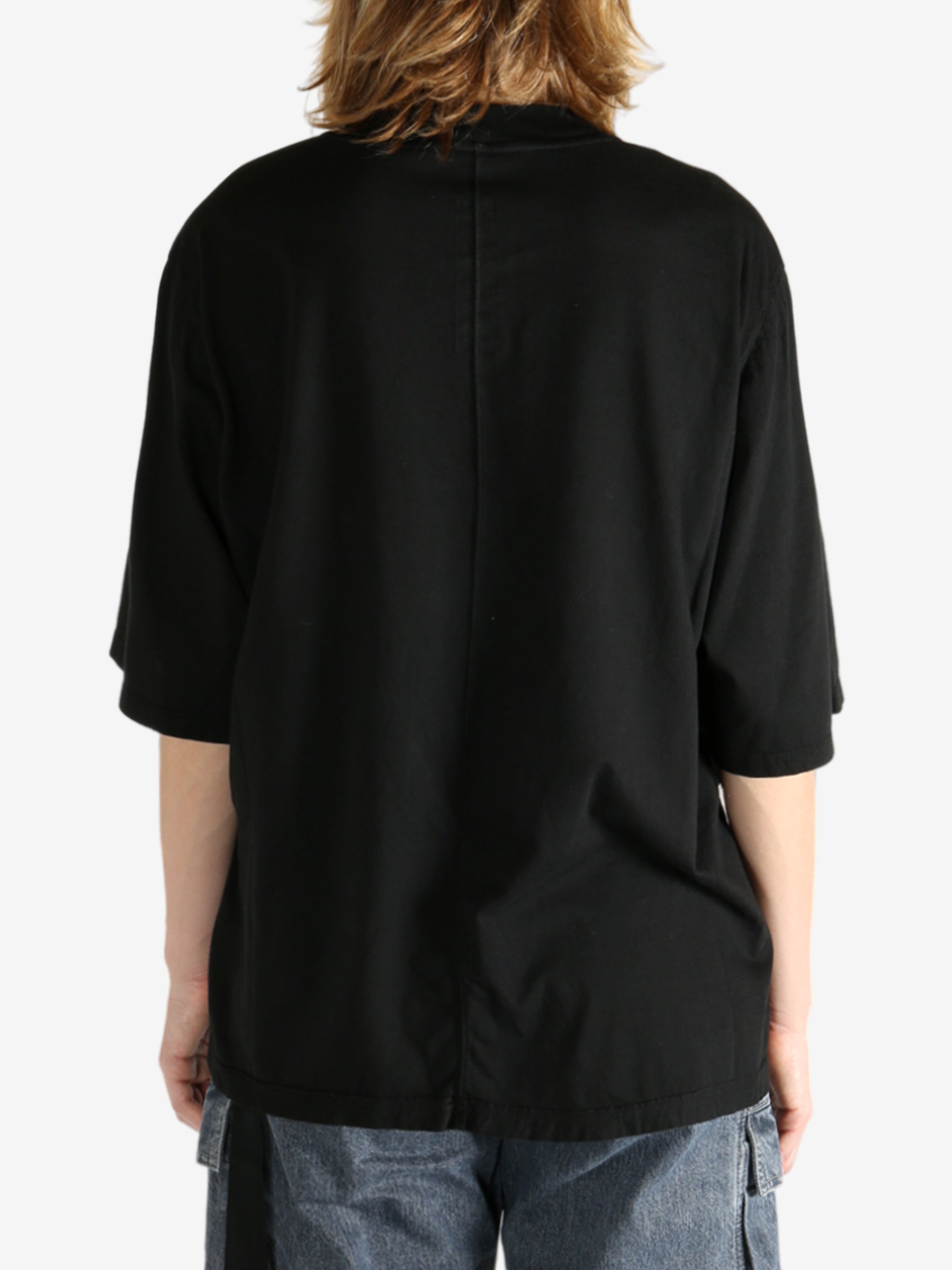 Black t-shirt worn by a person, showing the shirt's fit