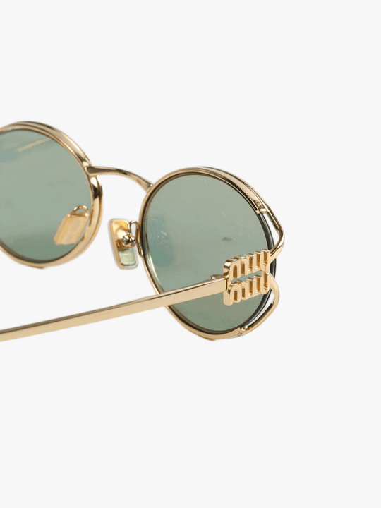 Close up of the green sunglasses, showing texture of the metal fabric