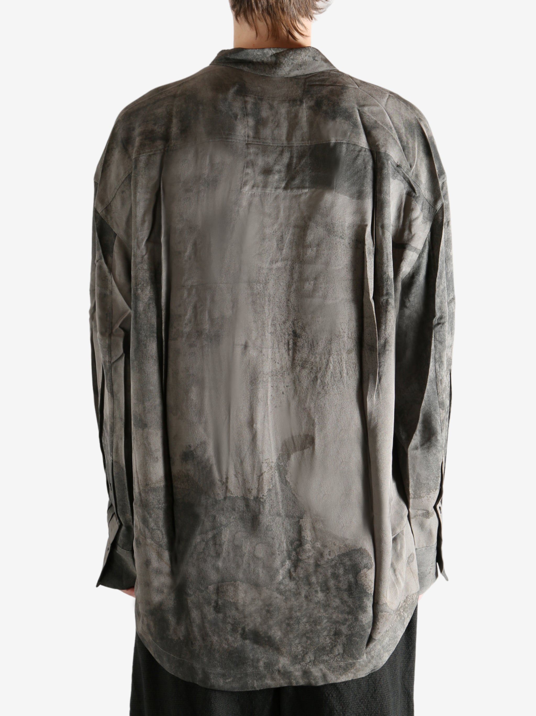 Grey shirt worn by a person, showing the shirt's it