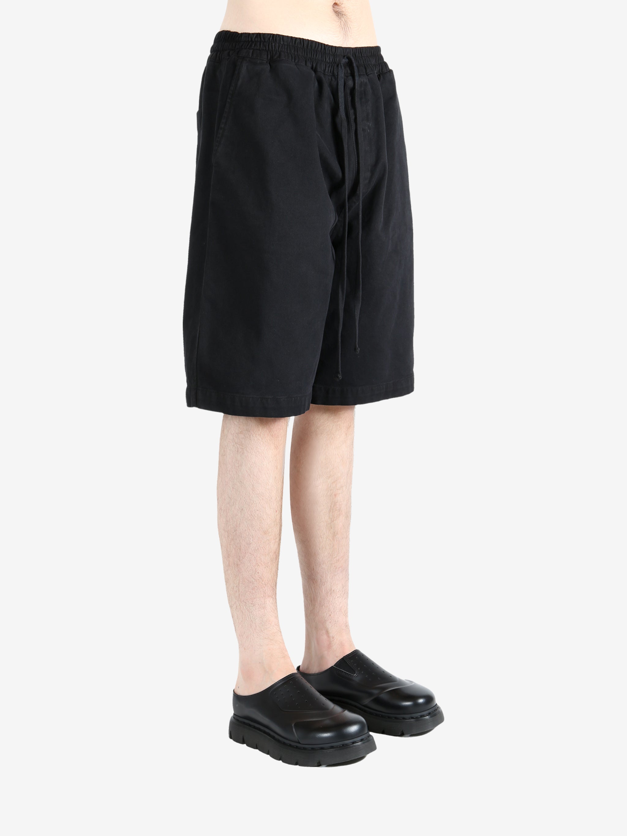 Black short worn by a person, showing the short's fit