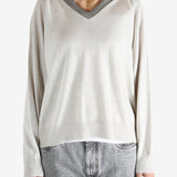 White knitwear worn by a person, showing the knitwear fit