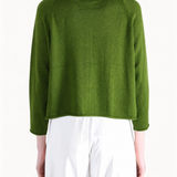 Green knitwear worn by a person, showing the knitwear fit
