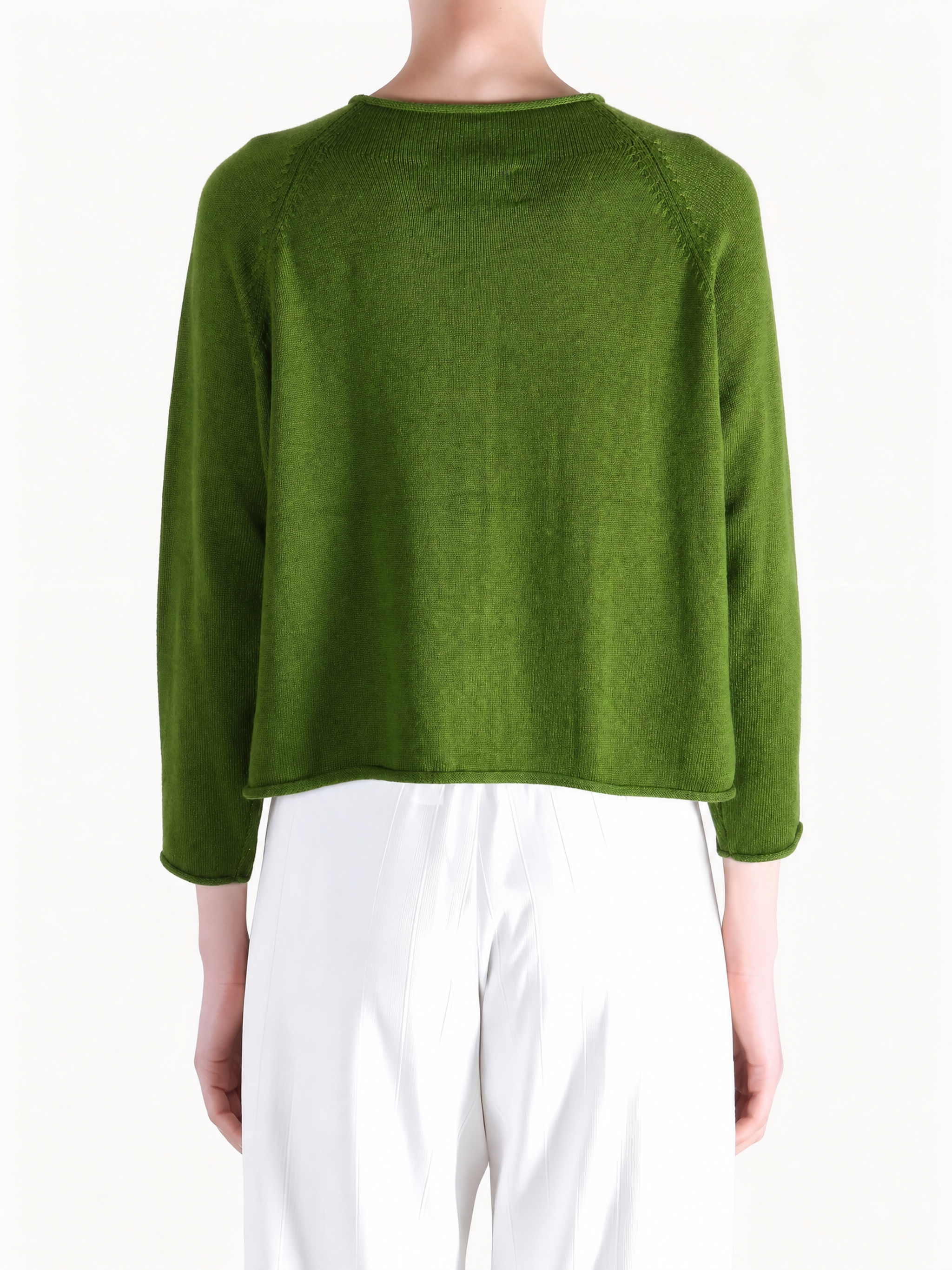 Green knitwear worn by a person, showing the knitwear fit