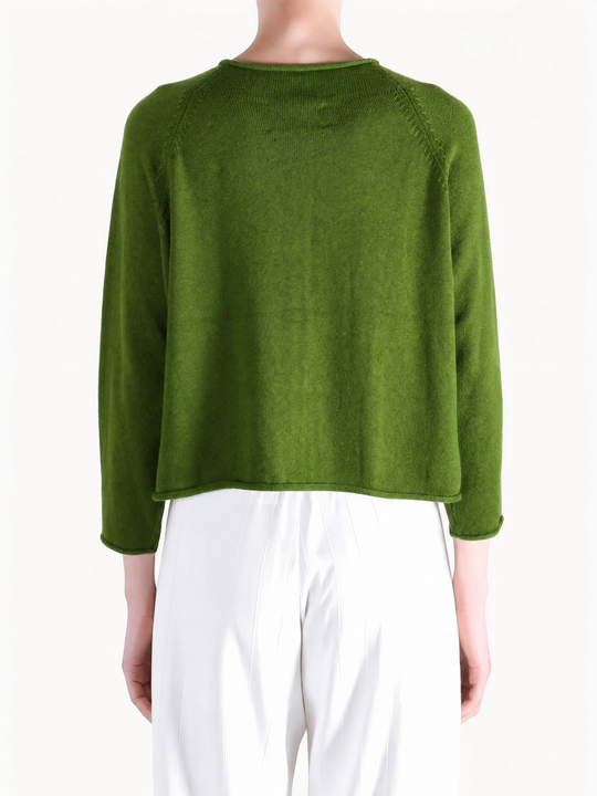 Green knitwear worn by a person, showing the knitwear fit