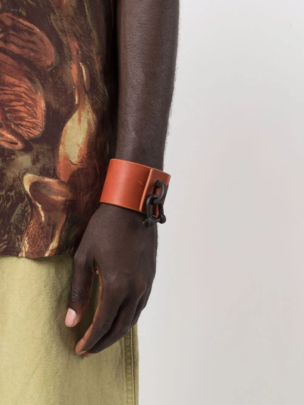 Red bracelet worn by a person, showing the bracelet fit