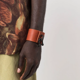 Red bracelet worn by a person, showing the bracelet fit