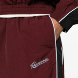 Burgundy pants worn by a person, showing the pants fit