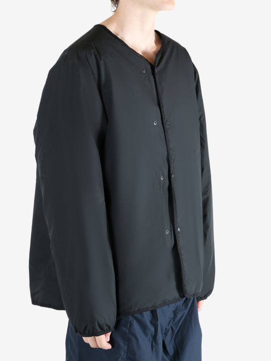 Black cardigan worn by a person, showing the cardigan's fit